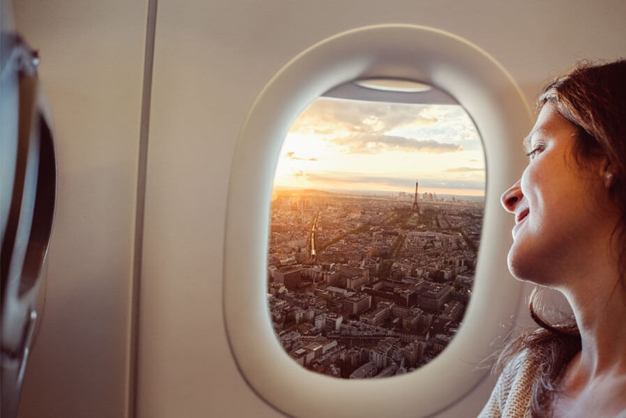 Woman looking out plane window